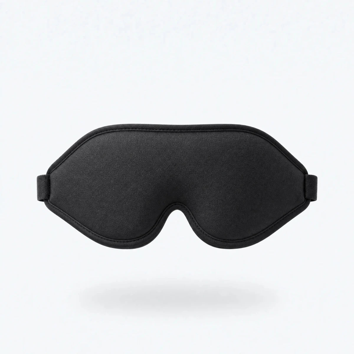 Black contoured sleep mask shown floating against a plain background