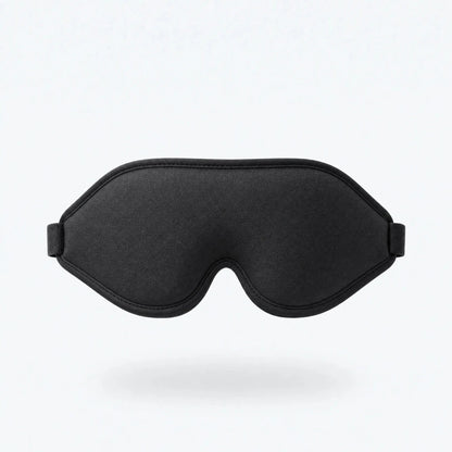 Black contoured sleep mask shown floating against a plain background